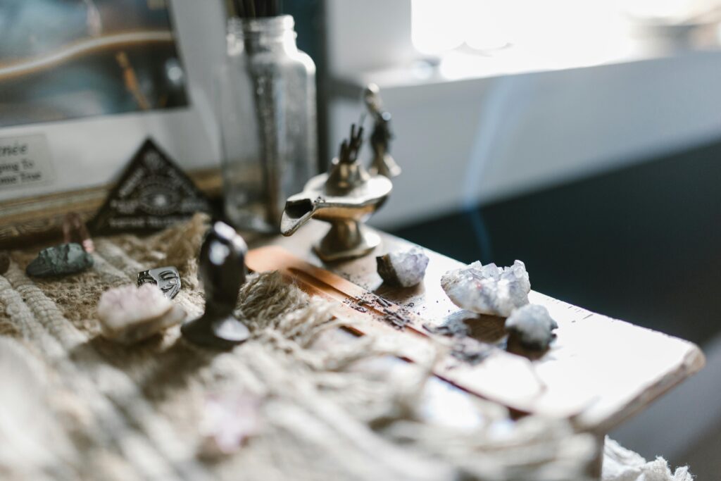 An enchanting arrangement featuring crystals and incense on a wooden surface, evoking tranquility and spirituality.