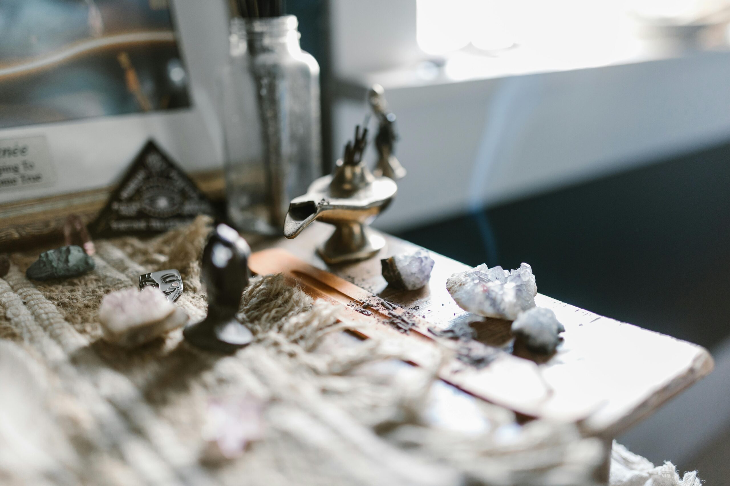 An enchanting arrangement featuring crystals and incense on a wooden surface, evoking tranquility and spirituality.